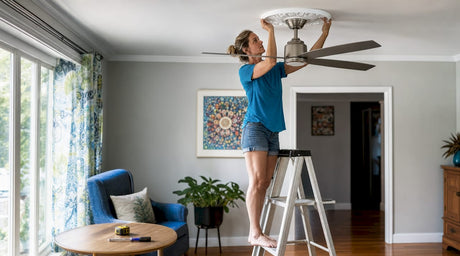 Woman installing ceiling medallion on fan